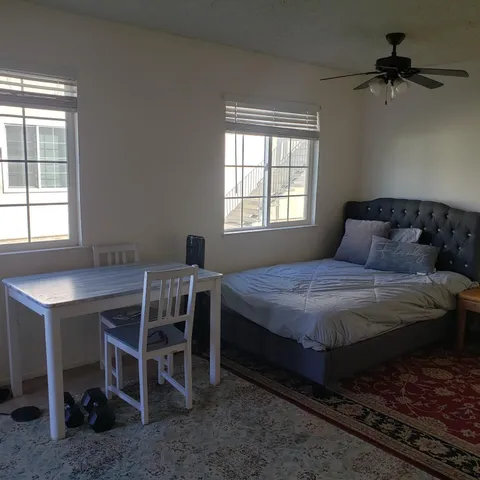 a bedroom with a bed and a window