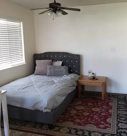 a bedroom with a bed and window