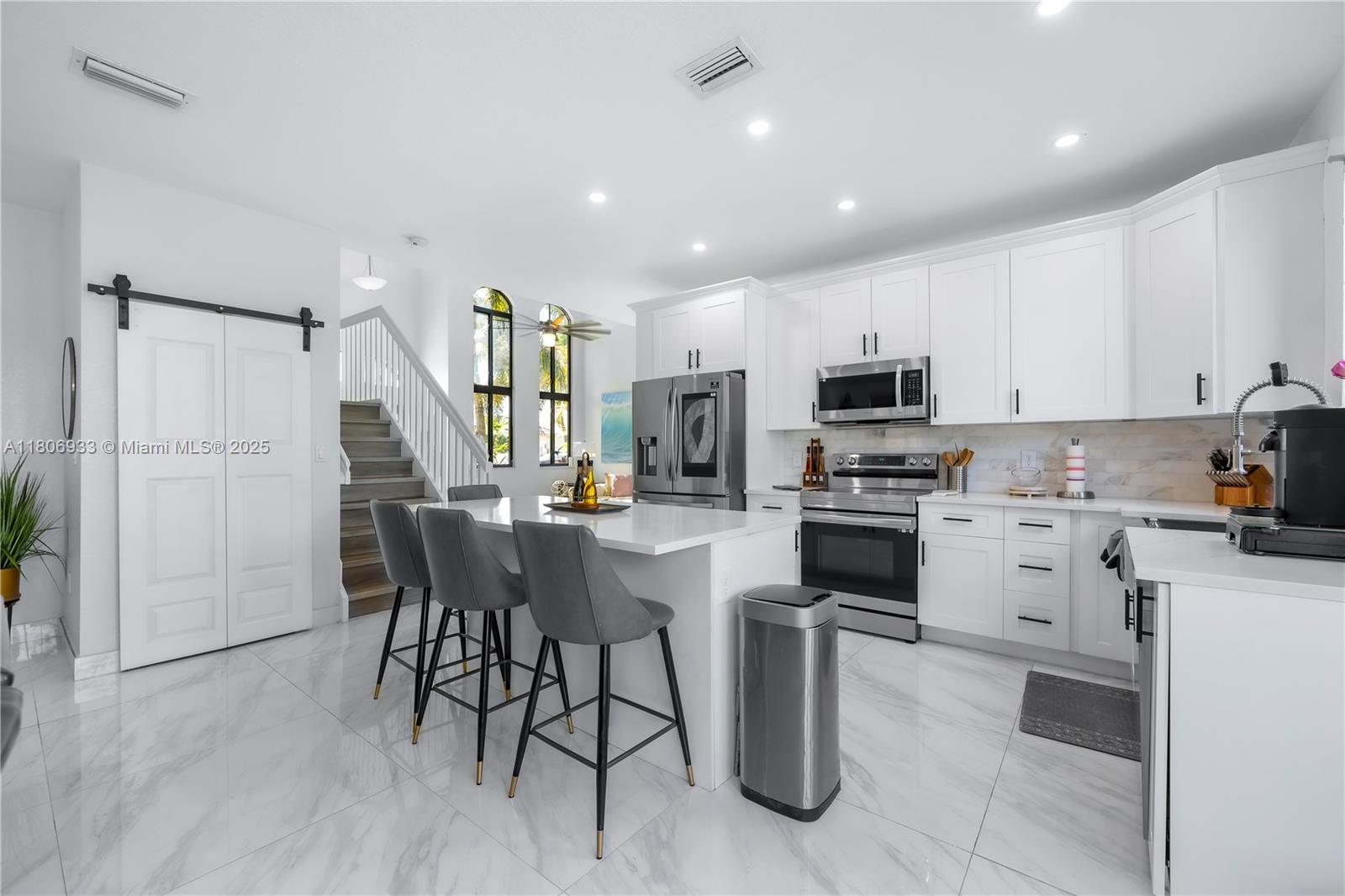 1857 Southeast 20th Road Homestead, FL 33035 - Photo 8 of 31 a kitchen with a sink stainless steel appliances and white cabinets