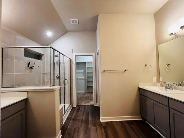 a bathroom with a double vanity sink toilet and shower