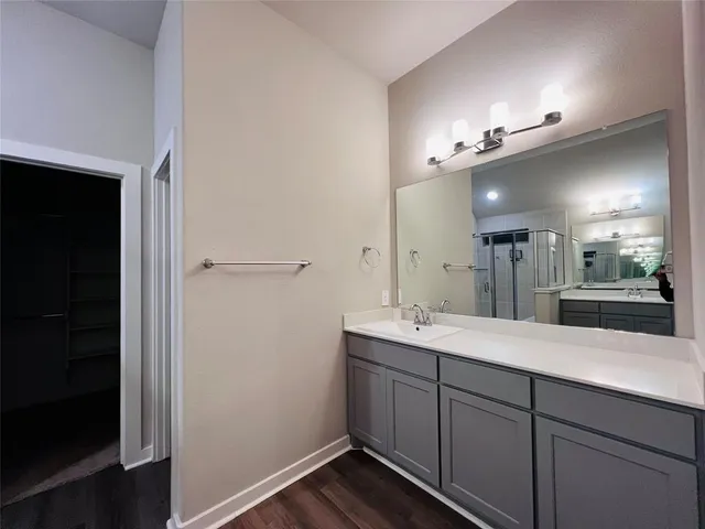 a spacious bathroom with a double vanity sink and a mirror