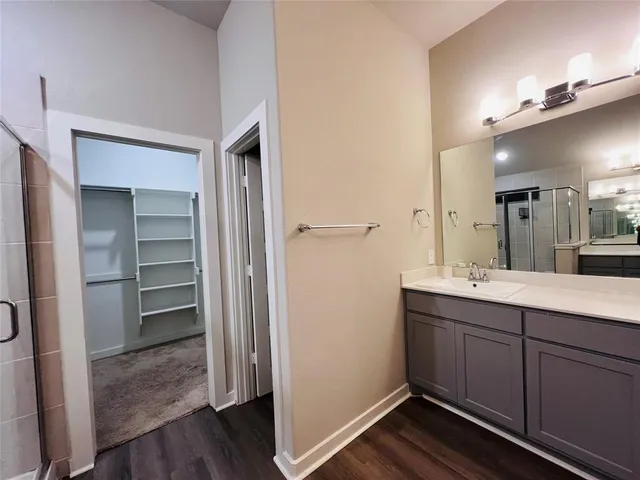 a bathroom with a double vanity sink and mirror