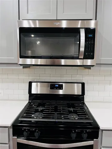 a stove top oven sitting inside of a kitchen