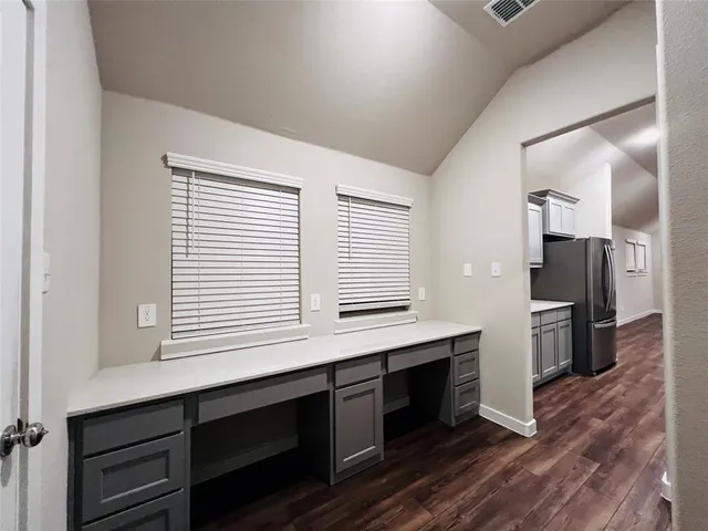 a kitchen with a refrigerator and a stove