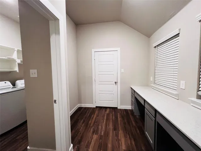 a kitchen with a sink and wooden floor