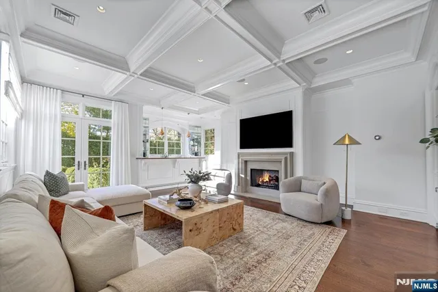 a living room with fireplace furniture and a flat screen tv