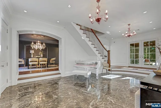 a view of a dining room with furniture and a chandelier