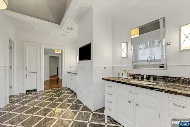 a en suite bathroom with a double vanity sink and a window