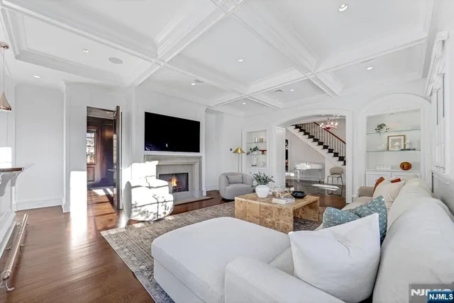a very nice looking dining room with a large window and stainless steel appliances