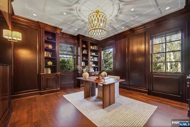 a dining room with furniture a chandelier and wooden floor