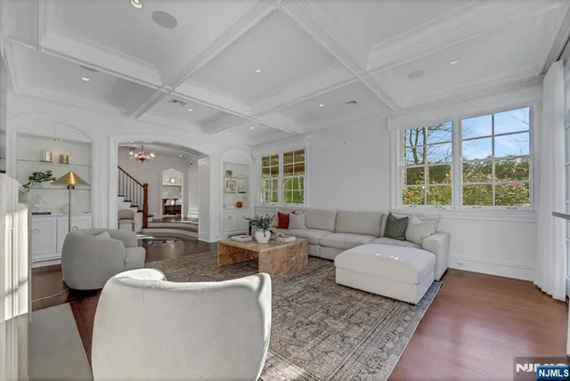 a very nice looking dining room with a large window and stainless steel appliances