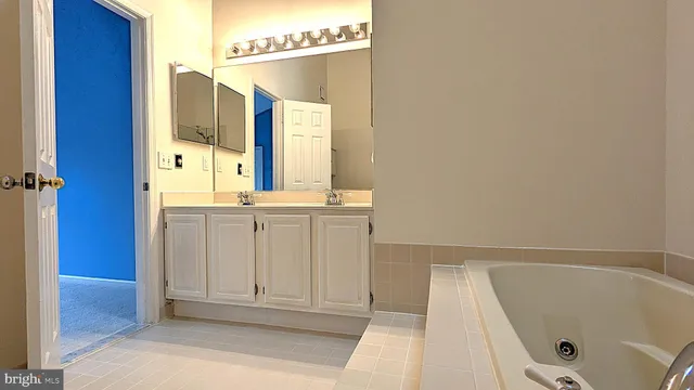 a bathroom with a tub and a shower