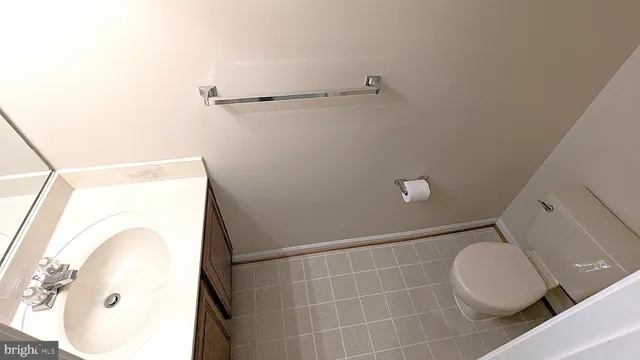 a bathroom with a toilet and a mirror