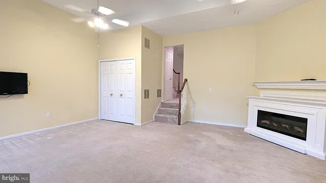 a view of an empty room with a fireplace