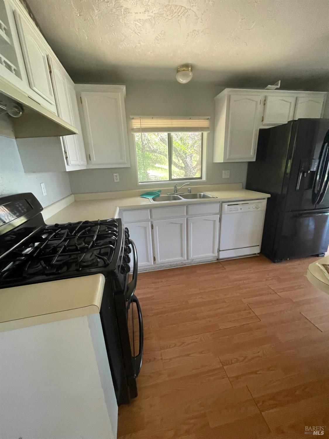 7630 Walnut Lane Lower Lake, CA 95457 - Photo 5 of 11 a kitchen with a sink a stove and refrigerator