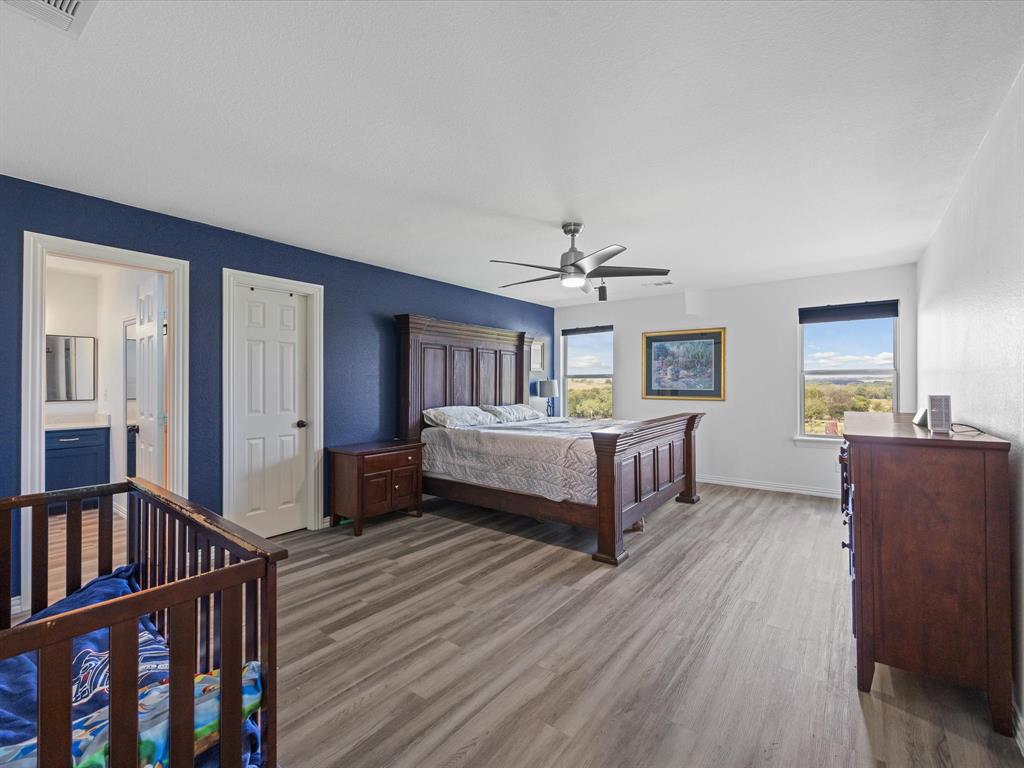 781 Alsdorf Road Ennis, TX 75119 - Photo 8 of 39 a bedroom with furniture and a wooden floor