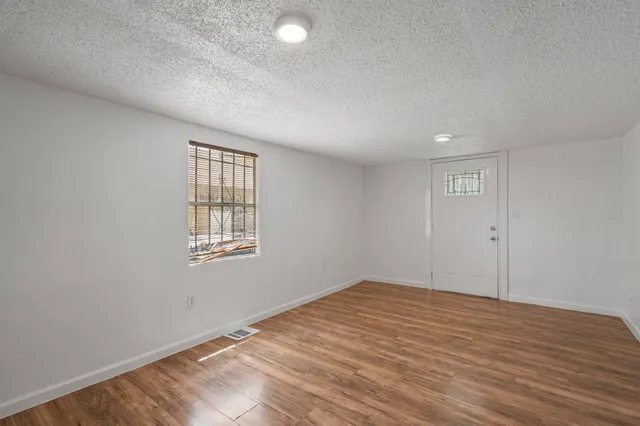 wooden floor in an empty room with a window