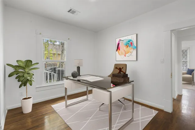 a view of a workspace with furniture and a potted plant