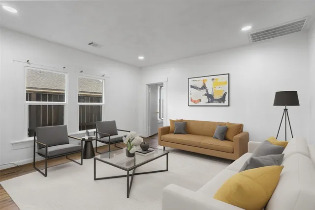 a living room with furniture and a potted plant