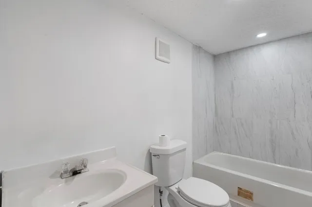 a bathroom with a sink toilet and bathtub
