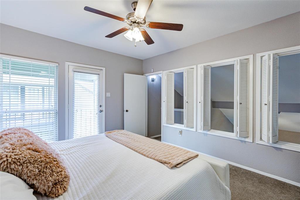 5981 Arapaho Road, Unit 1004 Dallas, TX 75248 - Photo 12 of 16 Ceiling fan with light fixture, multiple windows with blinds, built-in shuttered windows, and a glass-paneled door