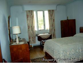 941 Hemlock Street Scranton, PA 18505 - Photo 3 of 4 a bedroom with a bed and wooden floor