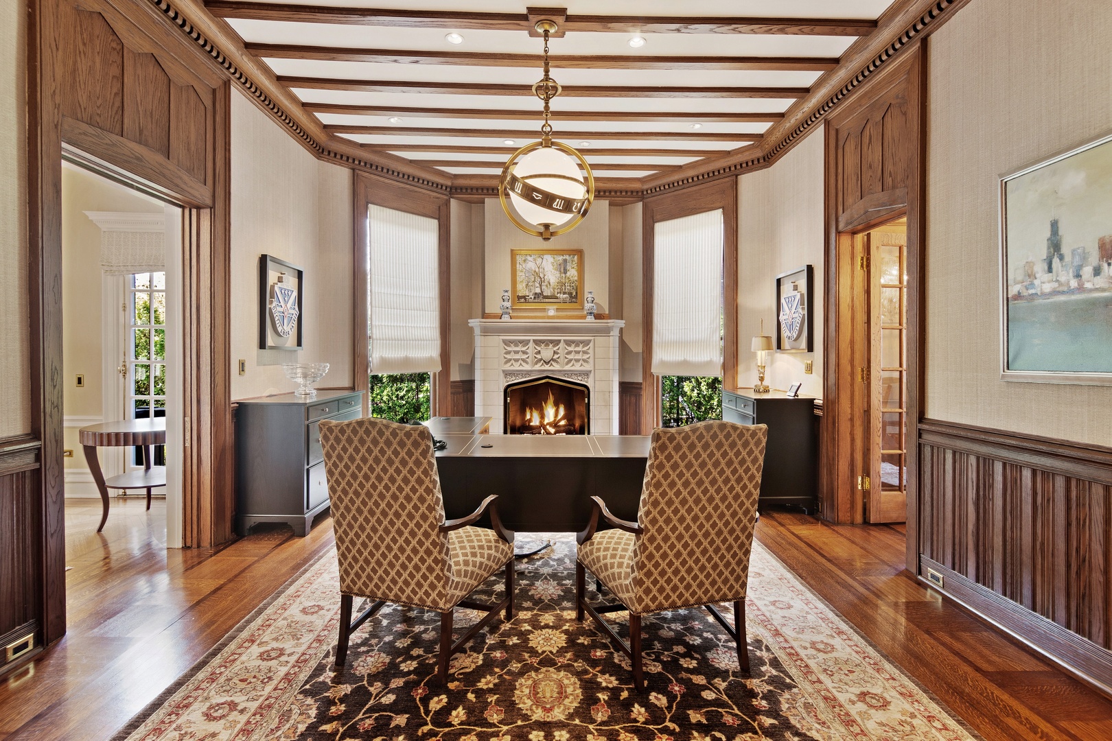 1622 Forest Place Evanston, IL 60201 - Photo 18 of 47 a dining room with furniture wooden floor a flat screen tv a fireplace and a chandelier