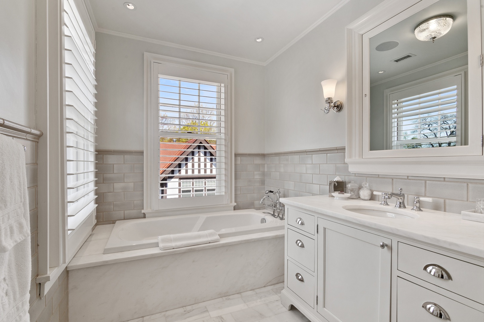 1622 Forest Place Evanston, IL 60201 - Photo 28 of 47 a bathroom with a tub a sink and a window