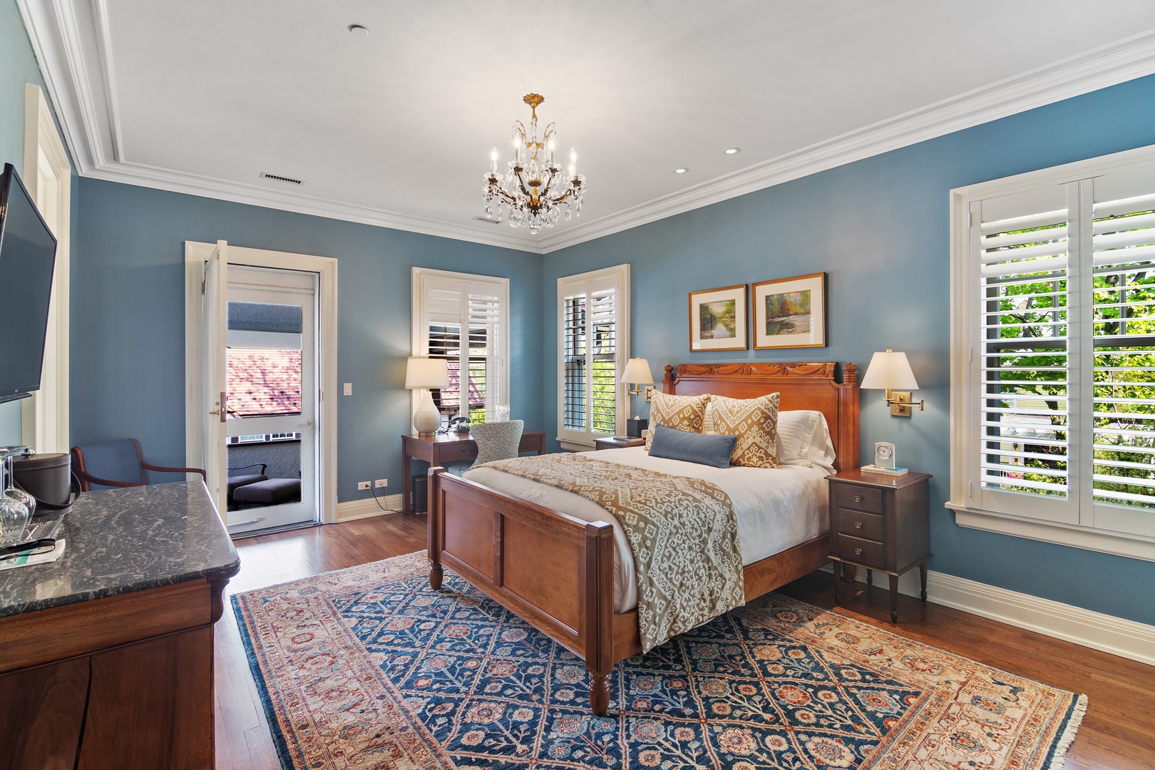 1622 Forest Place Evanston, IL 60201 - Photo 29 of 47 a spacious bedroom with a large bed a chandelier and windows