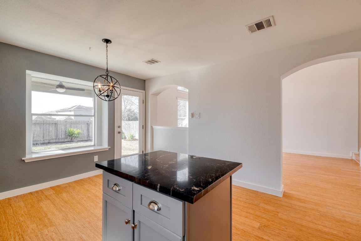12825 James Madison Street Manor, TX 78653 - Photo 11 of 24 a kitchen with stainless steel appliances granite countertop stove top oven and cabinets