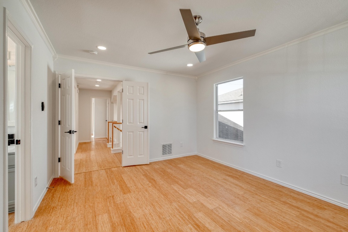 12825 James Madison Street Manor, TX 78653 - Photo 16 of 24 a view of a livingroom with a hardwood floor and a ceiling fan