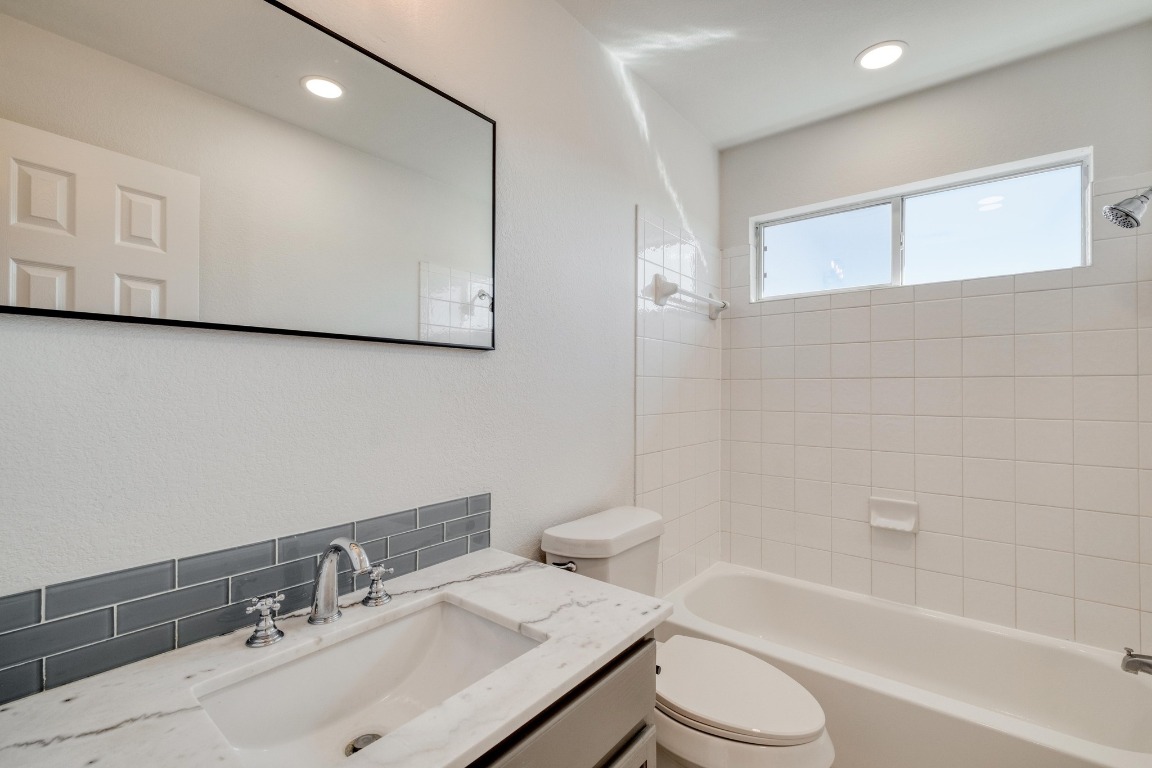12825 James Madison Street Manor, TX 78653 - Photo 21 of 24 a bathroom with a sink toilet and shower