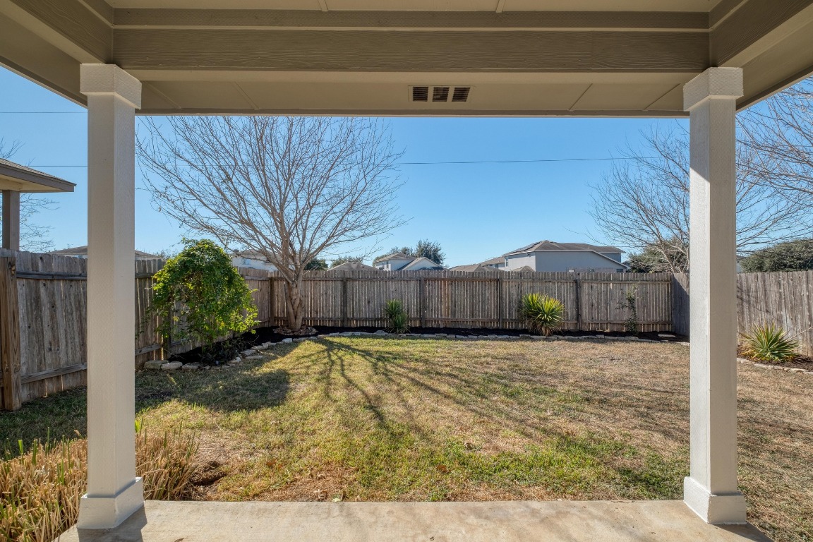 12825 James Madison Street Manor, TX 78653 - Photo 22 of 24 a view of a house with a small yard and wooden fence