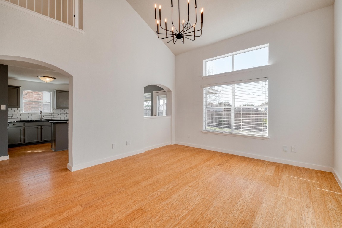 12825 James Madison Street Manor, TX 78653 - Photo 5 of 24 a view of an empty room with a window and wooden floor