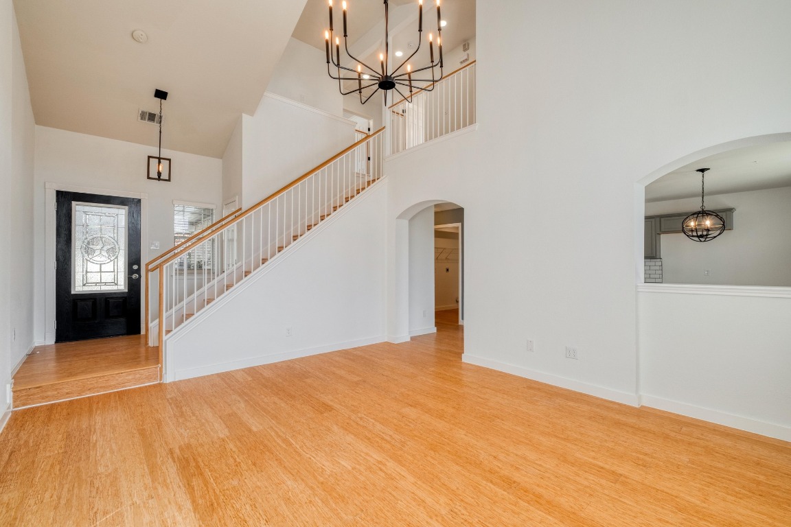 12825 James Madison Street Manor, TX 78653 - Photo 7 of 24 a view of a hallway with a chandelier