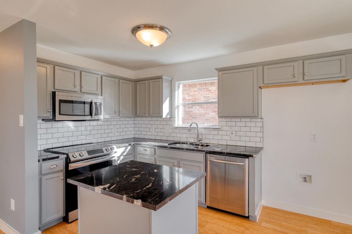 12825 James Madison Street Manor, TX 78653 - Photo 8 of 24 a kitchen with granite countertop a sink and a stove
