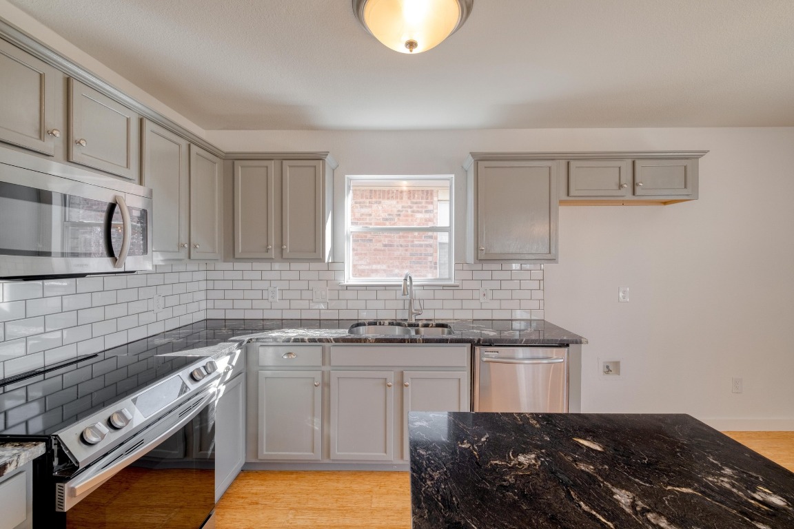 12825 James Madison Street Manor, TX 78653 - Photo 9 of 24 a kitchen with a sink stove and cabinets