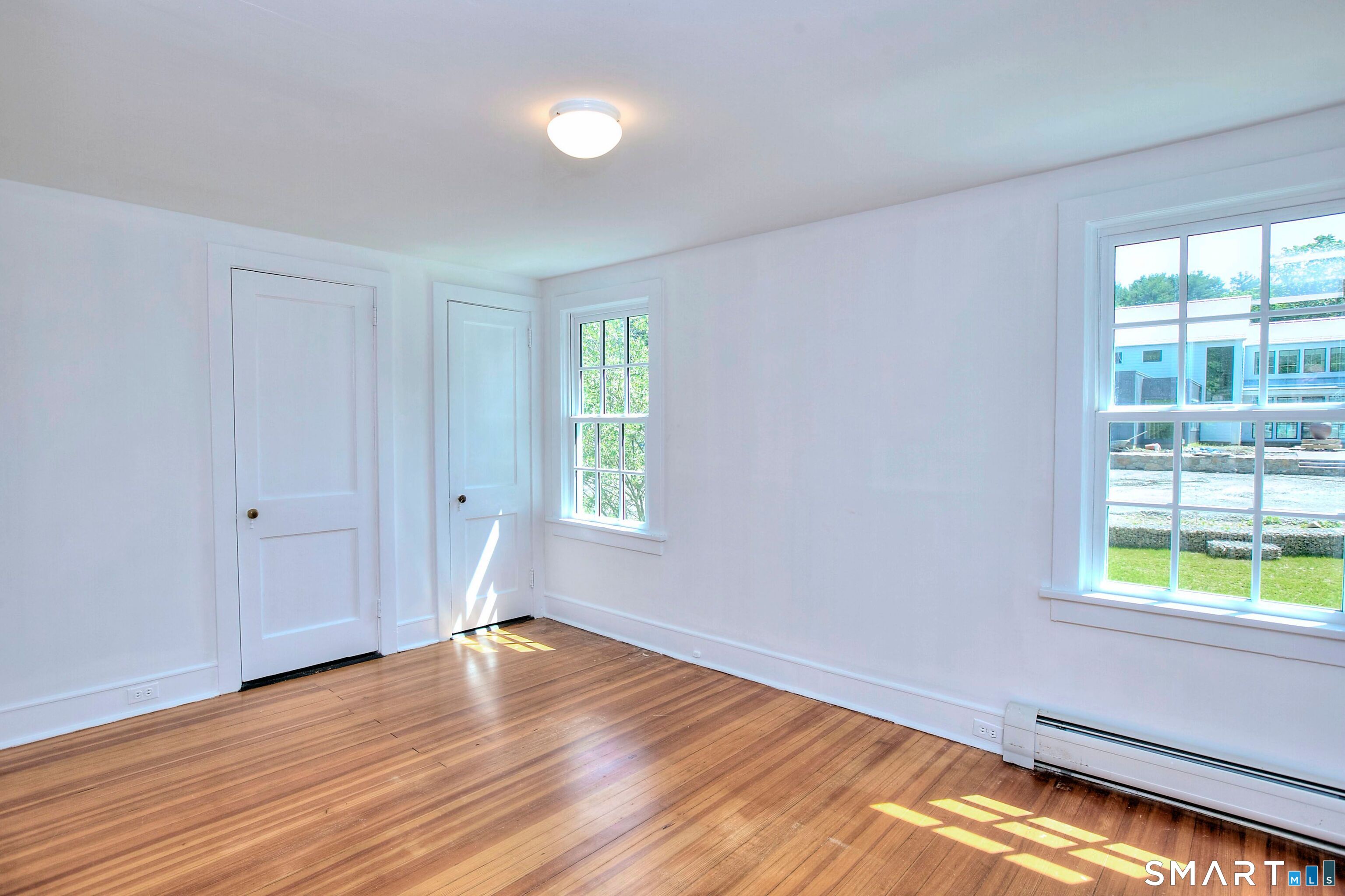 94 Honey Hill Road Wilton, CT 06897 - Photo 12 of 18 a view of an empty room with wooden floor and a window