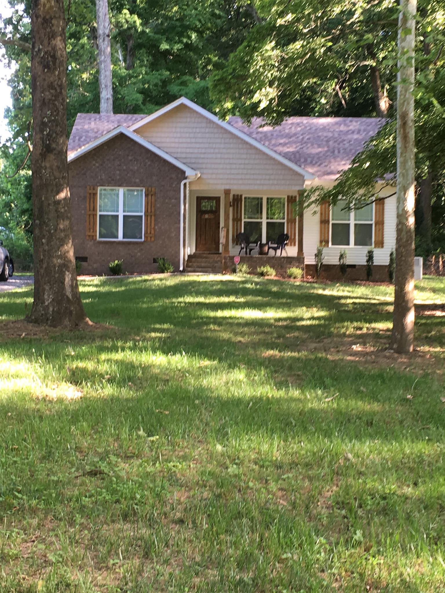 121 Point Road Portland, TN 37148 - Photo 1 of 23 a front view of a house with a garden