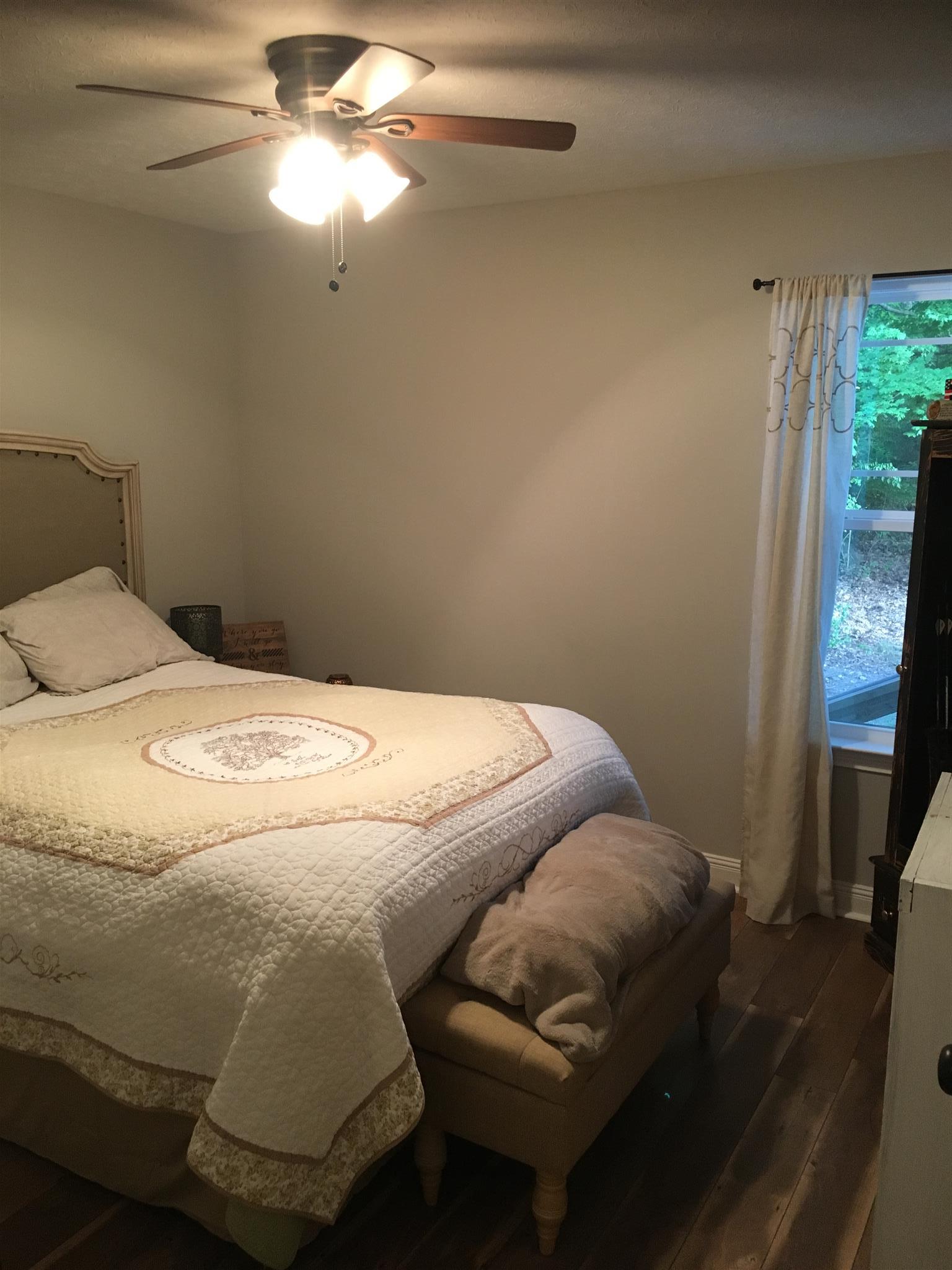 121 Point Road Portland, TN 37148 - Photo 19 of 23 a bedroom with a bed and a chandelier
