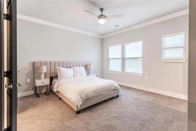 a spacious bedroom with a bed and a window