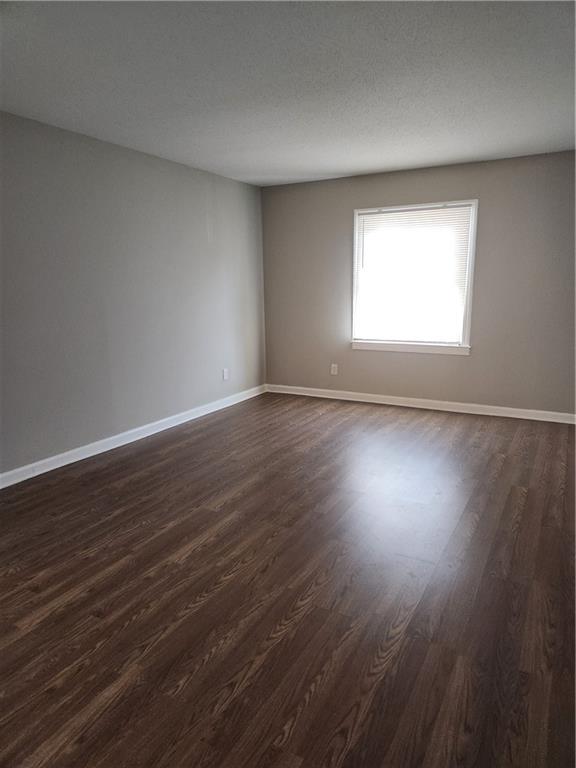94 Rue Fontaine Lithonia, GA 30038 - Photo 11 of 13 a view of an empty room with wooden floor and a window