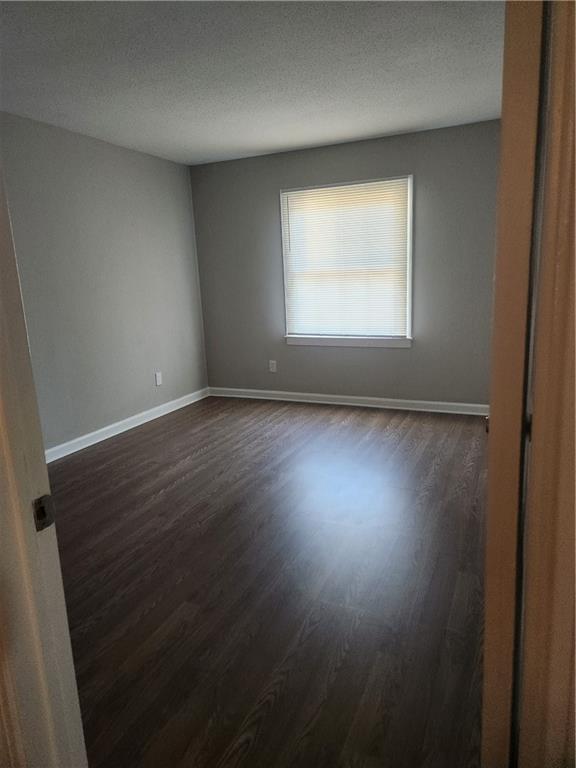 94 Rue Fontaine Lithonia, GA 30038 - Photo 10 of 13 an empty room with wooden floor and windows