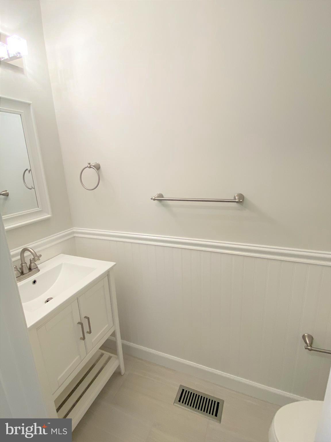 3933 Cutty Sark Road Baltimore, MD 21220 - Photo 23 of 69 a bathroom with a sink a toilet and a mirror