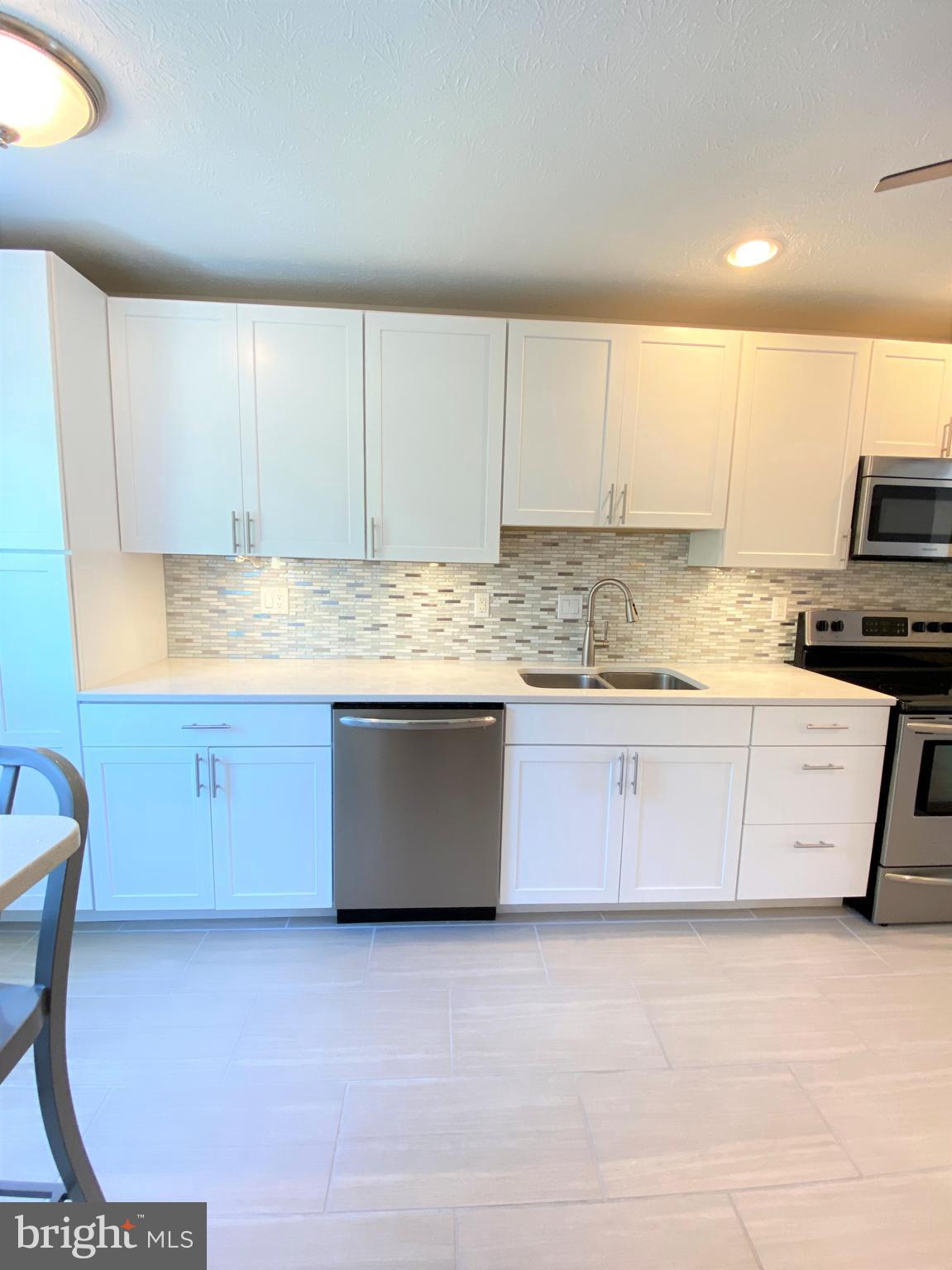3933 Cutty Sark Road Baltimore, MD 21220 - Photo 24 of 69 a kitchen with stainless steel appliances granite countertop a stove a sink and a microwave