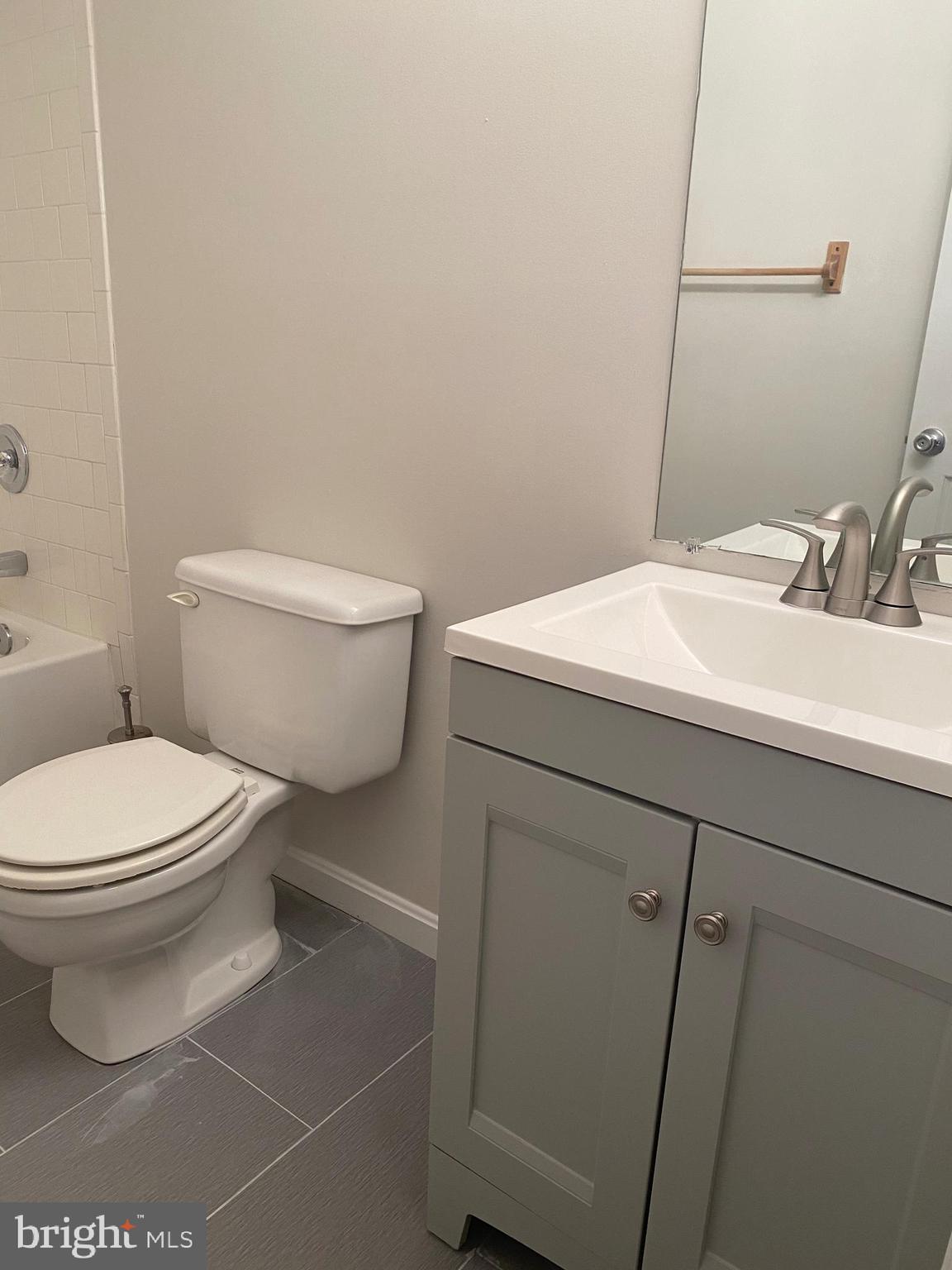 3933 Cutty Sark Road Baltimore, MD 21220 - Photo 46 of 69 a bathroom with a toilet a sink and a mirror