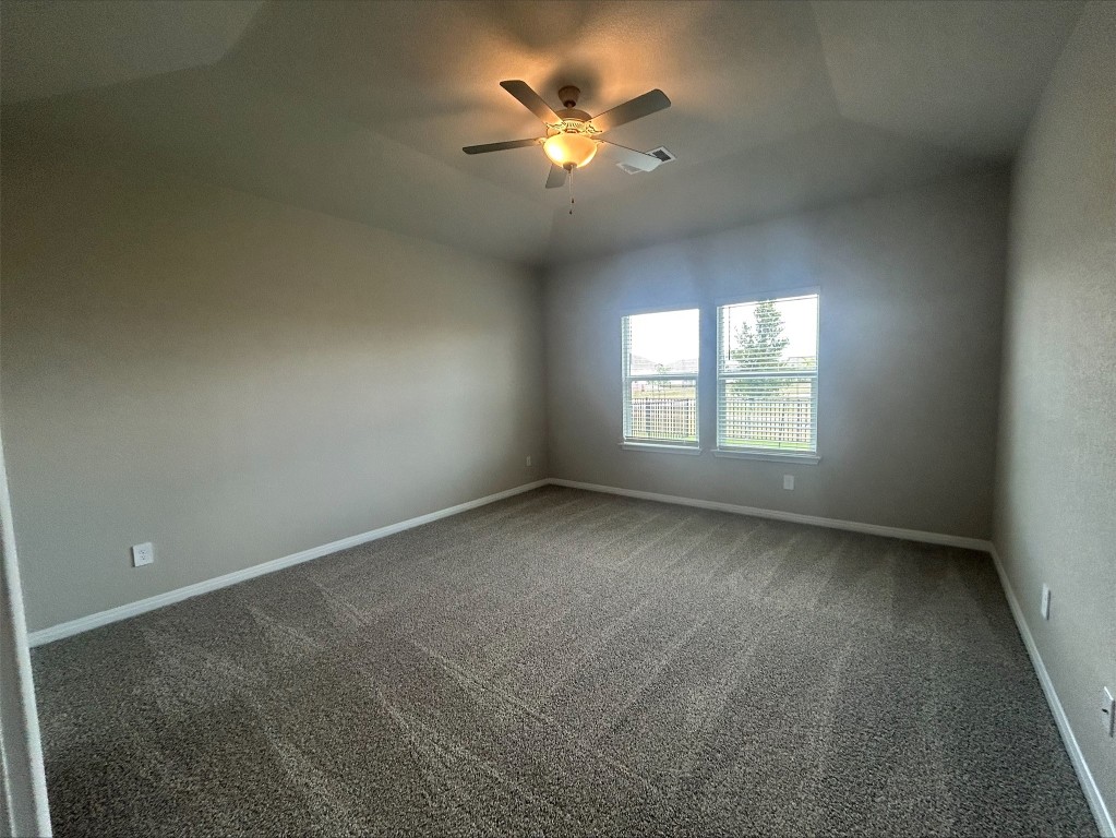 17112 Lomond Way Pflugerville, TX 78660 - Photo 8 of 9 Spare room with ceiling fan and carpet floors