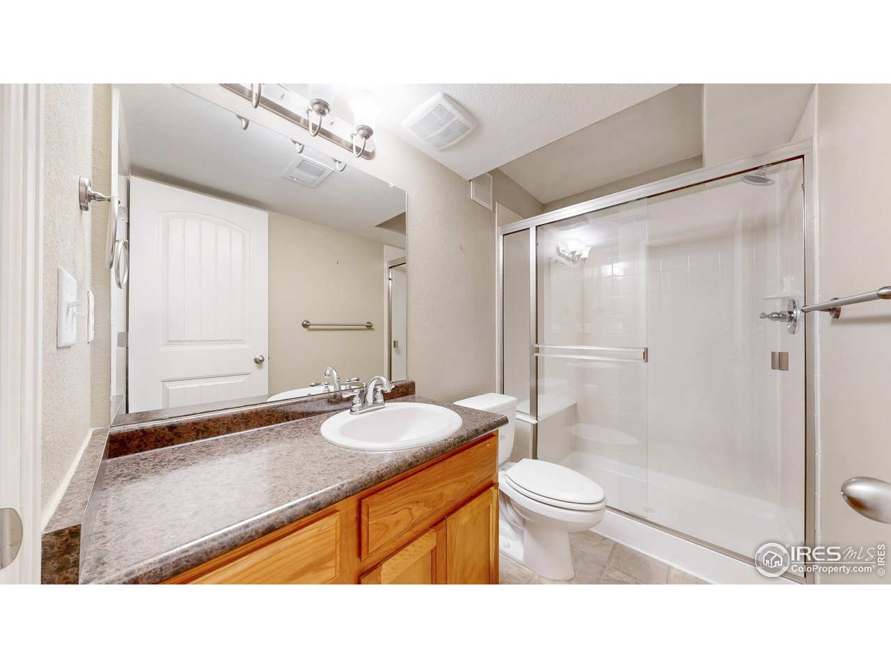 419 Clark Street Johnstown, CO 80534 - Photo 12 of 31 a bathroom with a sink a toilet a mirror and shower