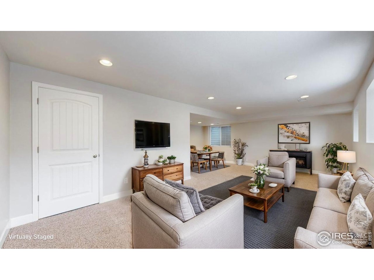 419 Clark Street Johnstown, CO 80534 - Photo 14 of 31 a living room with furniture and a flat screen tv