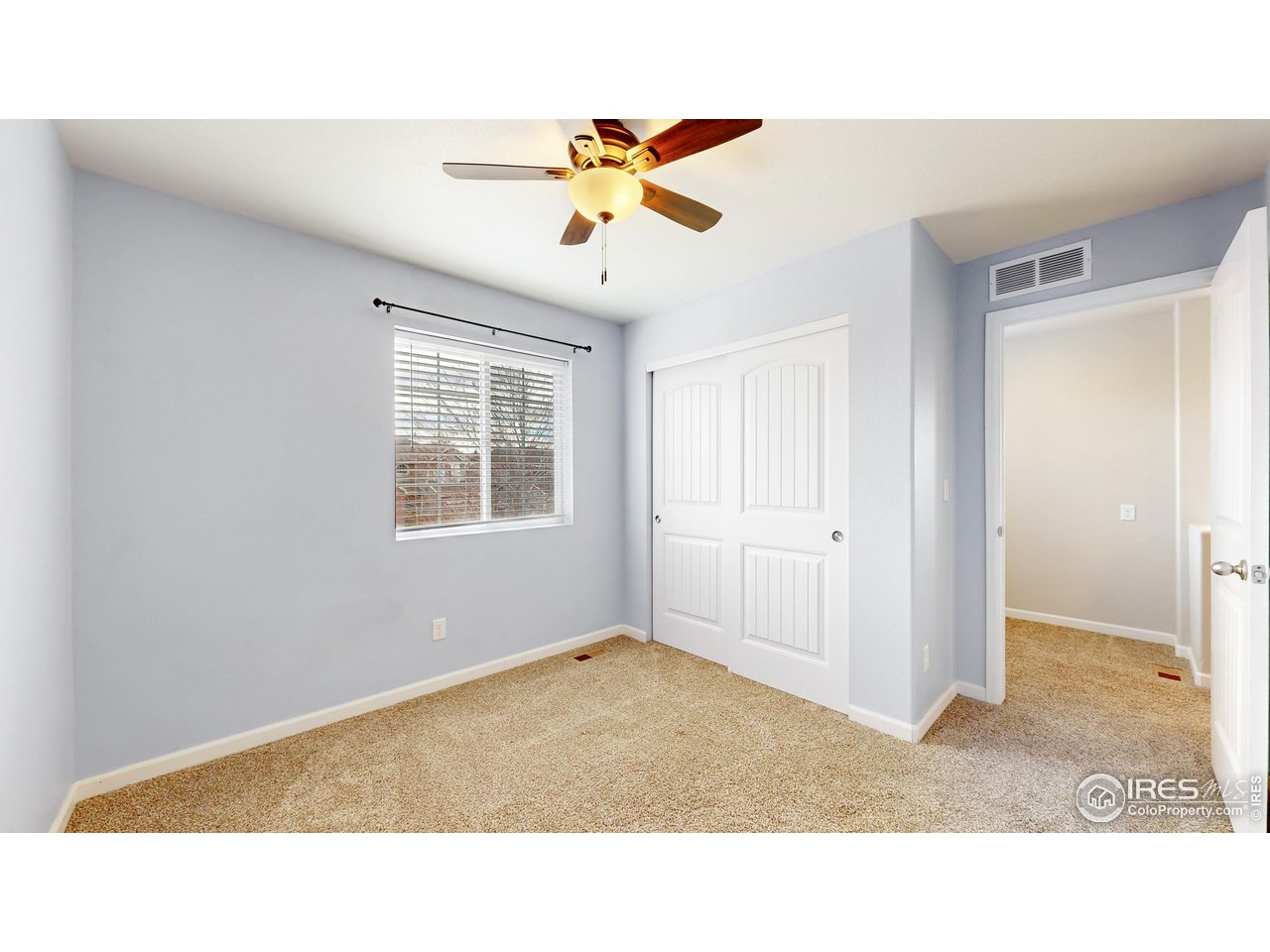 419 Clark Street Johnstown, CO 80534 - Photo 15 of 31 a living room with a ceiling fan and a window